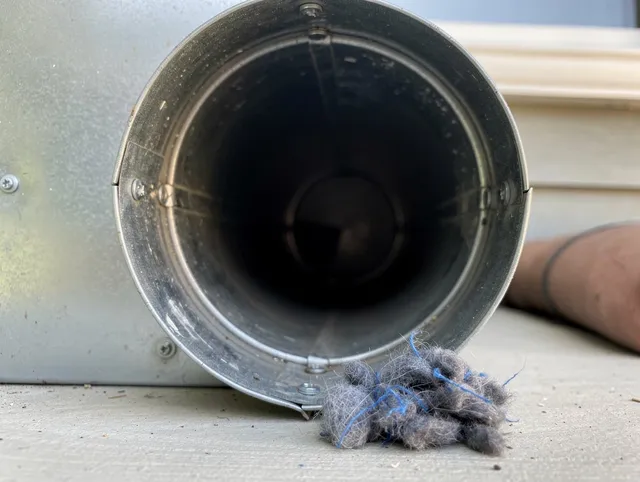 Brunswick Dryer Vent Cleaning technician using specialized equipment to clear severe dryer vent blockage in Brunswick